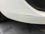 a close up of a car ' s front bumper and fender