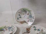 four plates and a bowl on the table