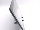 a tablet computer sitting on a stand on a white surface