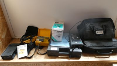 a black bag sitting on top of a shelf next to other items