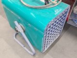 a blue box with a hose attached to it in a store