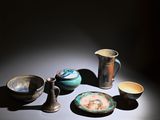 many different types of pottery displayed on the table