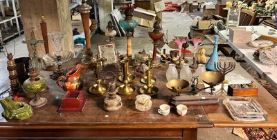 a lot of antique items on a table in a room