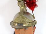 a helmet with a red feather on top of a mannequin head