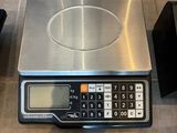 a digital scale with a calculator on it