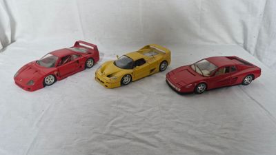 four toy cars that are sitting on a white surface