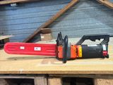 a chainsaw sitting on top of a pallet in a warehouse