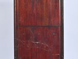 a tall wooden cabinet with a mirror on top of it