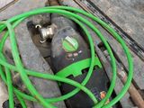 a green hose that is connected to a machine