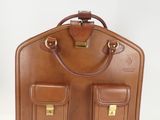 brown leather suitcase with two pockets and a handle