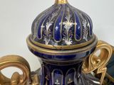 a blue and gold vase sitting on top of a table