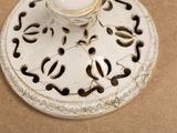 a candle holder with a candle on it on a table