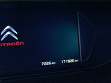 a picture of a car dashboard with a car in the background