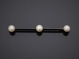 a pair of pearl and gold barbells