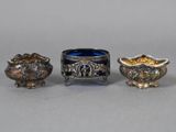 three silver and blue glass dishes sitting on top of a table