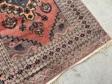 an image of a rug on the ground with a cat laying on it