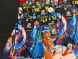 several pairs of underwear are lined up on a black surface