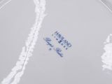 a close up of a white plate with blue writing on it