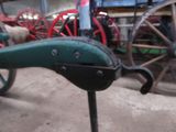 a close up of a green and black horse drawn carriage