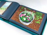 a book with a picture of a potted plant inside of it