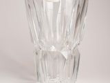 a clear glass vase with a small candle inside of it