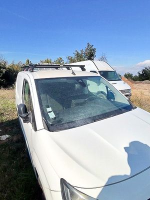 a white car that is parked on the side of the road