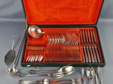 an assortment of silverware including spoons, forks and spoons in a case
