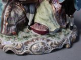 a figurine of a man and a woman sitting on a bench