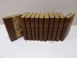 a group of six books sitting on top of a white table