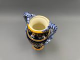 une tasse bleue et jaune avec une anse, posée sur une table