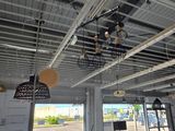 a large room with a lot of lights hanging from the ceiling