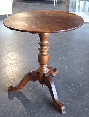 a wooden table with a wooden top on a black tile floor