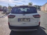 a white car that is parked on the side of the road