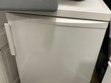 a white refrigerator and a silver refrigerator freezer next to each other