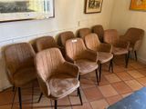 five chairs in a row in a room with a painting on the wall