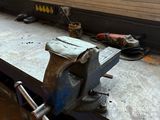 a viset that is sitting on a workbench in front of a window