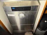 stainless steel dishwasher in a kitchen with a dirty cloth on the floor