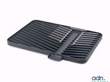 a close up of a black grill pan on a white background