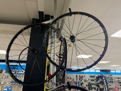 two bikes that are on the rack in the store