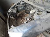a car that is sitting in the garage with its hood up