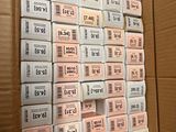 a lot of boxes of cigarettes sitting in a cardboard box
