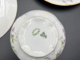 a cup and saucer sitting on a table next to another cup and saucer