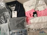 a lot of clothes that are sitting on a table