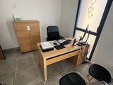 two chairs and a desk in a room with a large window