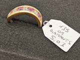 une bague en or sertie de pierres roses, avec une étiquette indiquant le prix