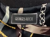 the back of a woman ' s neck with a black and brown scarf
