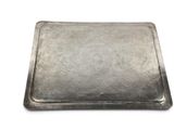 rectangular silver tray on a white background with a pattern on the surface