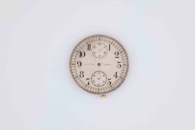 a clock that is sitting on a white surface