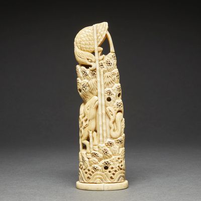 a carved ivory figurine of a woman and a bird