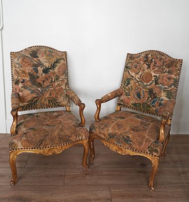pair of antique upholstered armchairs with floral upholstered upholstered cushions